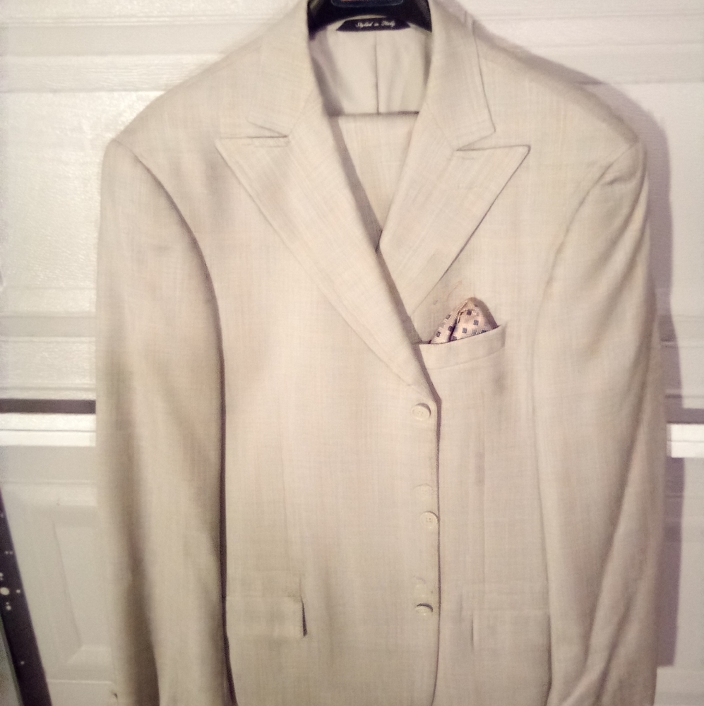 A Man suit tan plaid in color size 44 long Italian design suit three button suit